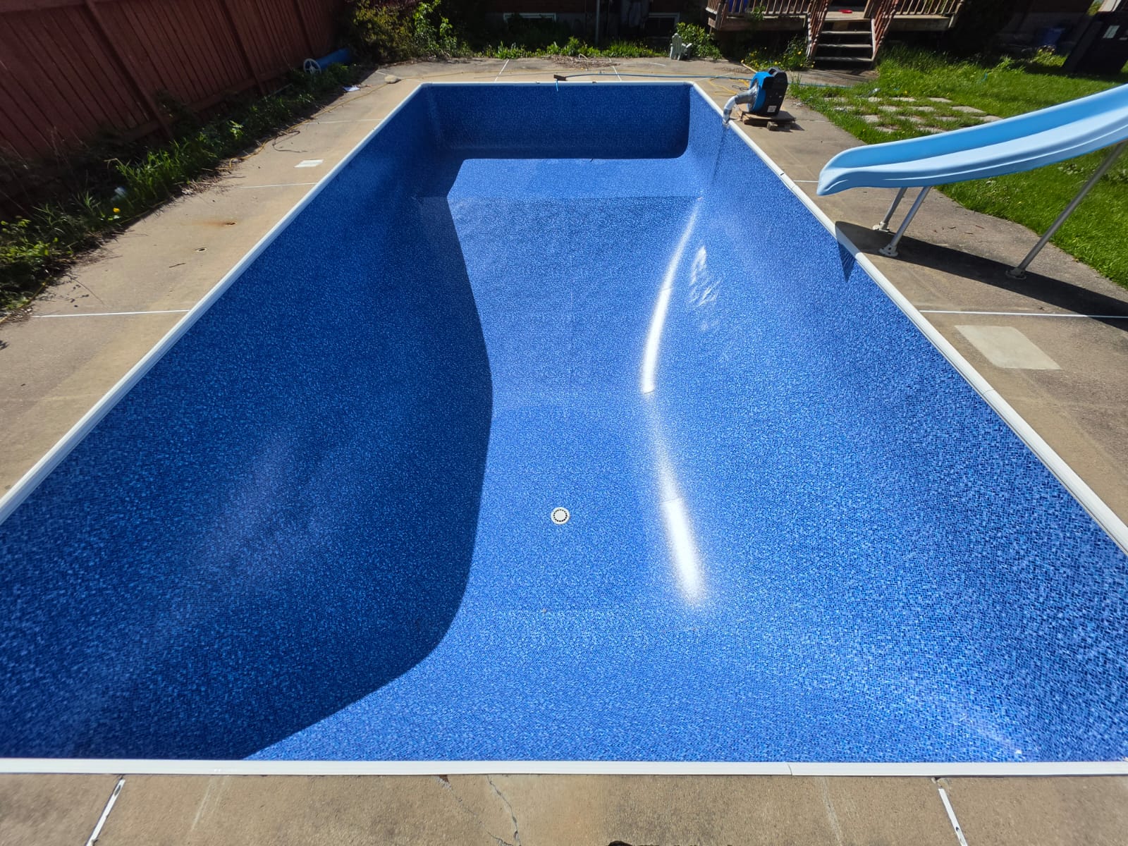 New vinyl pool liner fitted inside an empty pool