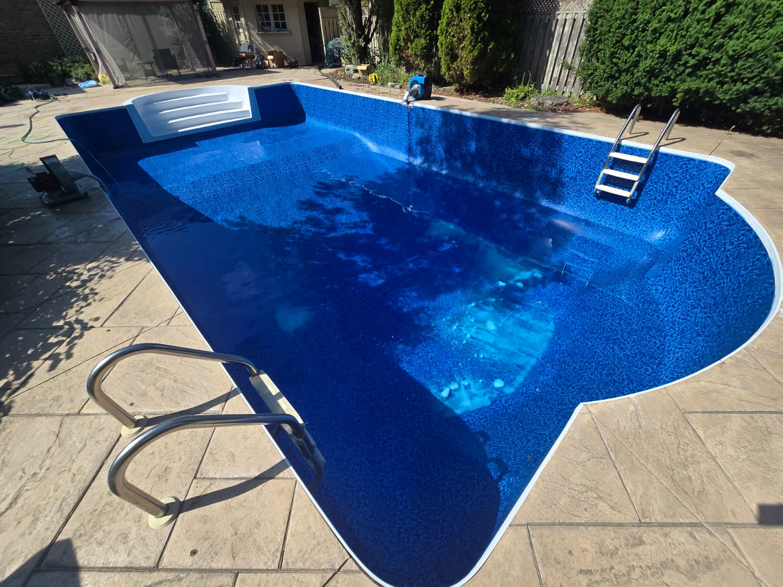 An OPS pool project with vivid blue water and a curved pool edge