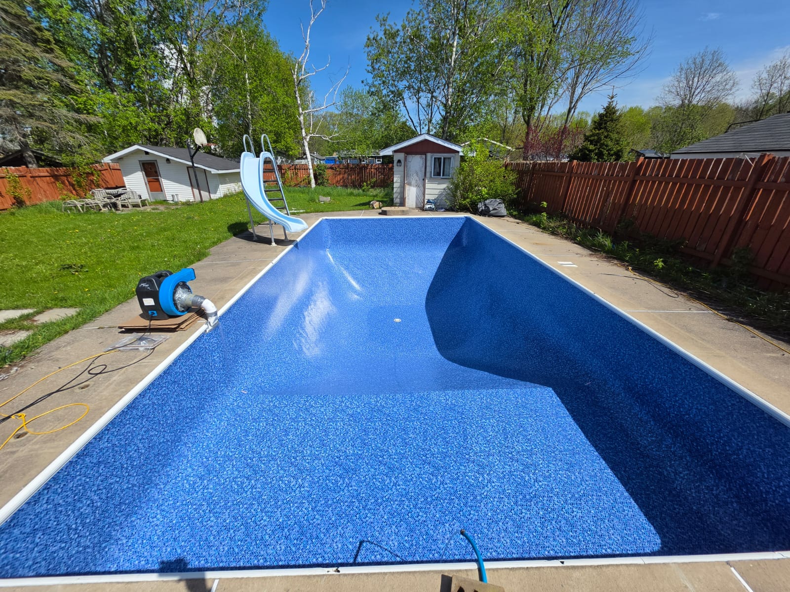 Blue residential pool being prepared for use